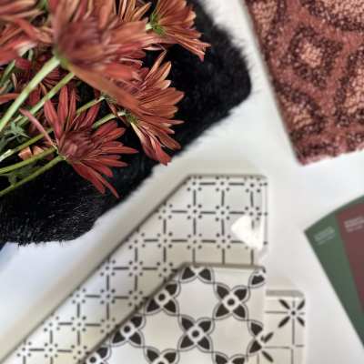 fire sign mood board with black and white mix and match tile, flowers and bold red patterned carpet